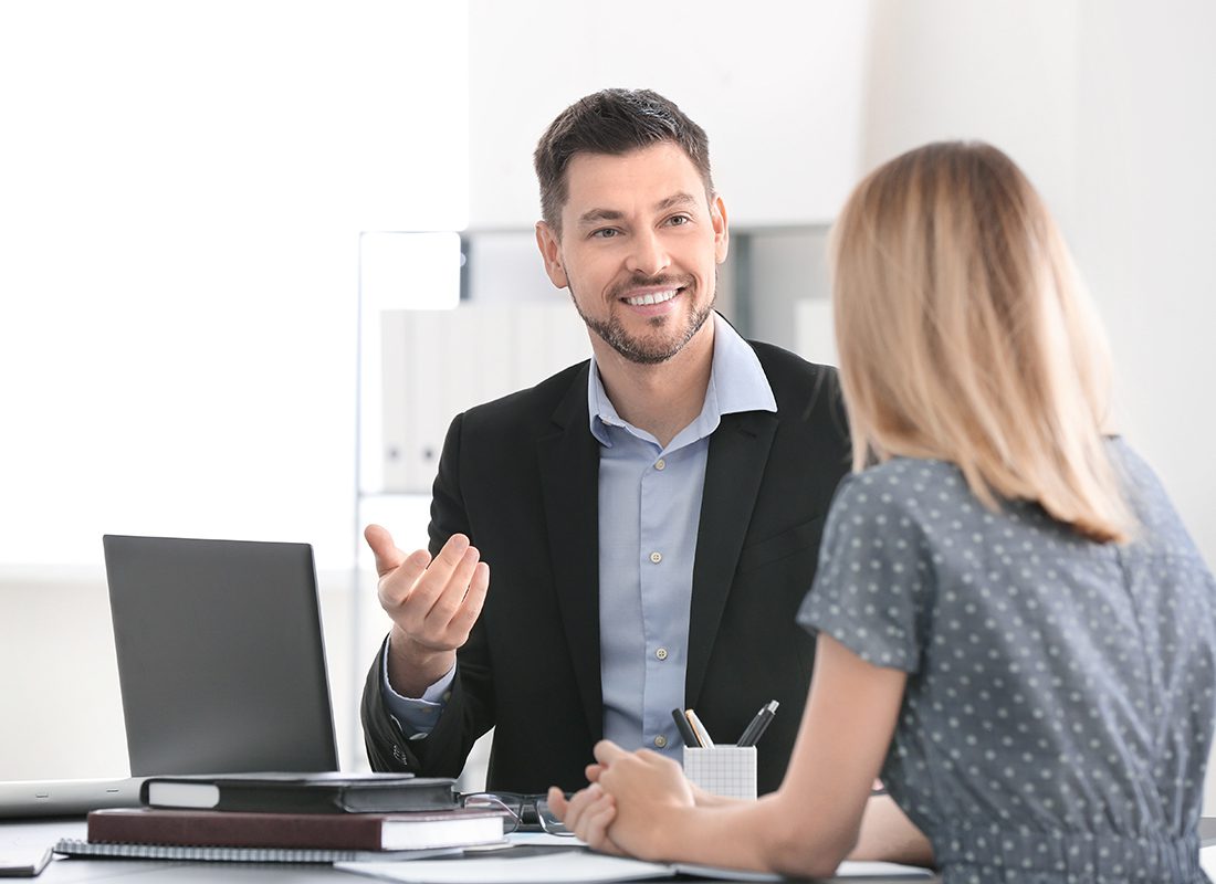 Contact - Friendly Agent Speaks With a Client at His Office