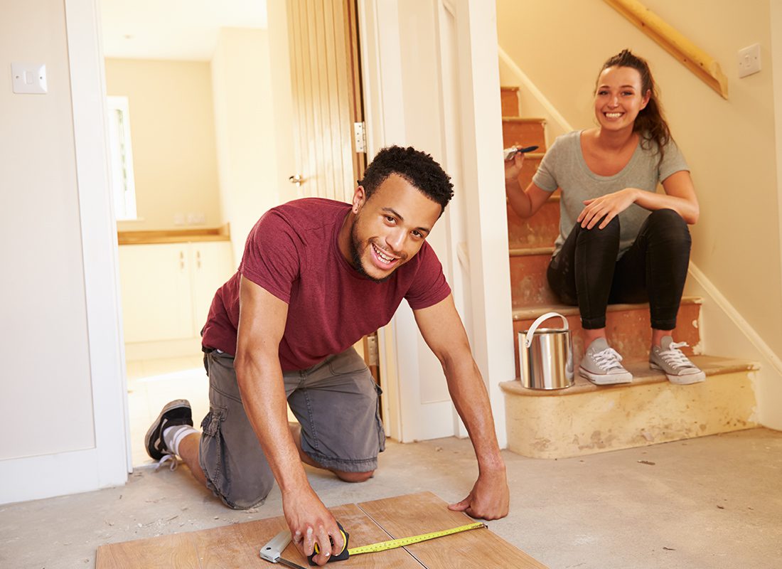 Personal Insurance - Happy Couple Work Together on Some Renovation Projects in the House